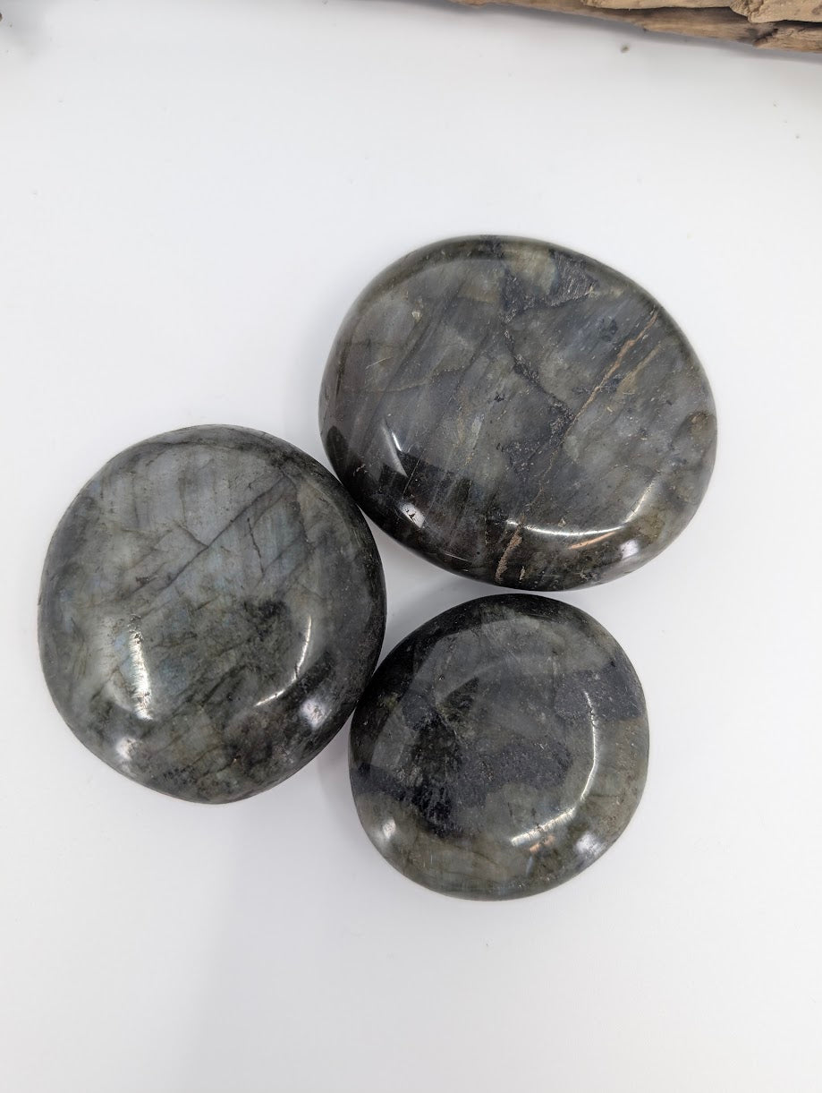 Group of labradorite palm stones with natural gray tones and subtle labradorescence