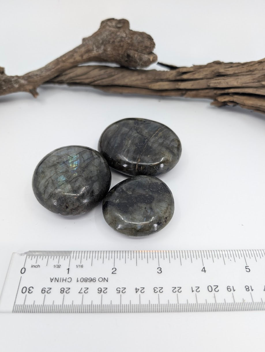 Close-up of labradorite palm stone highlighting internal structure and flash
