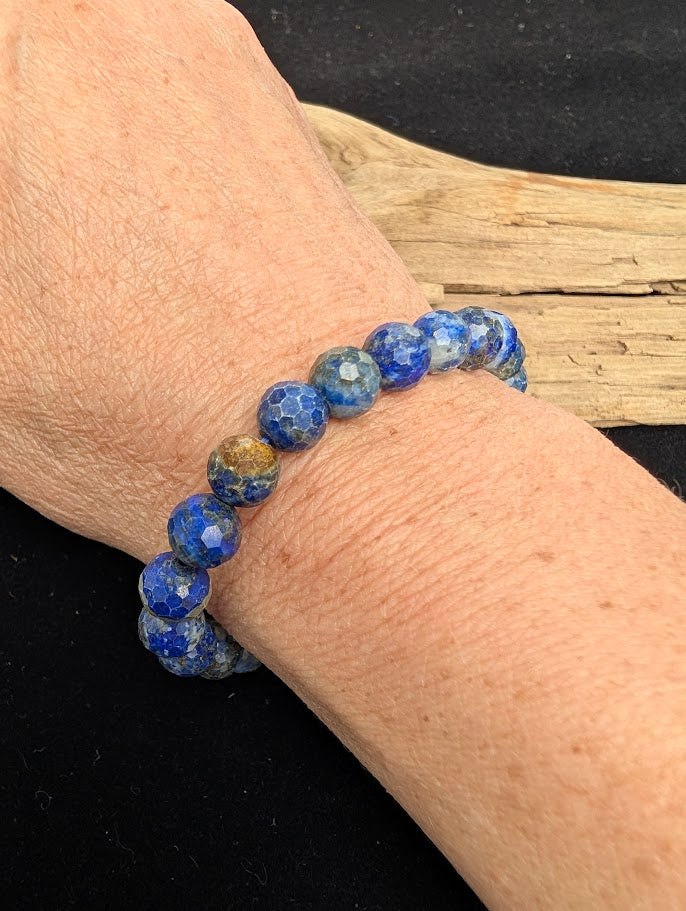 8mm faceted Lapis Lazuli beaded stretch bracelet worn on a wrist for size scale.