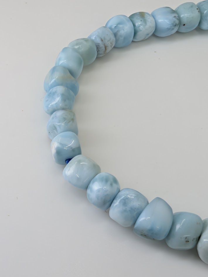 Detailed view of Larimar nugget beads with light and color variation