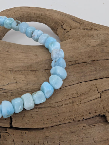 Close-up of Larimar nugget beads showing glossy finish