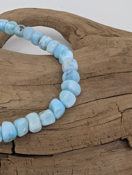 Close-up of Larimar nugget beads showing glossy finish
