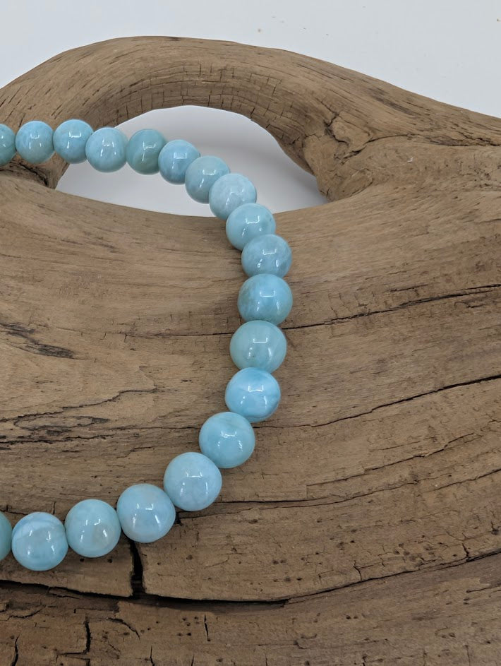 Close-up of Larimar beads showing gentle white marbling