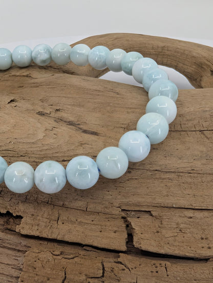 Close-up of 6mm Larimar beads with light marbling and high polish