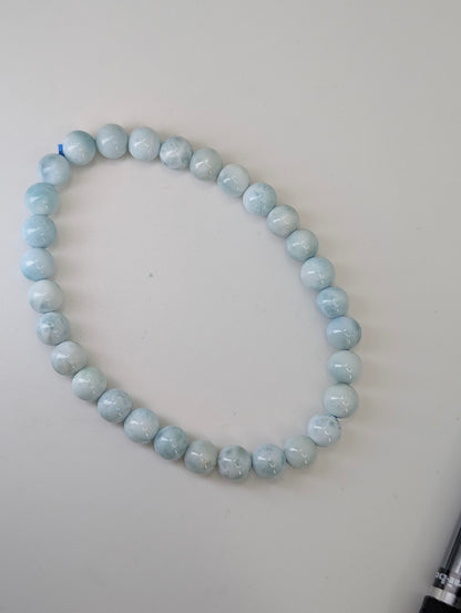Full circle view of natural 6mm Larimar bracelet in pale blue