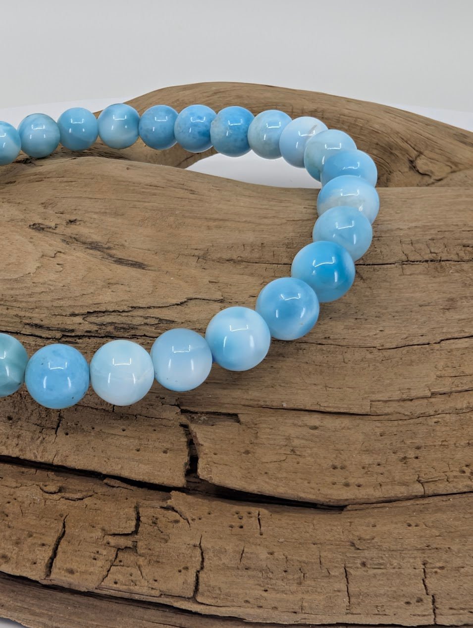 Closeup of Natural Larimar bracelet 6mm AA grade with soft blue marbling