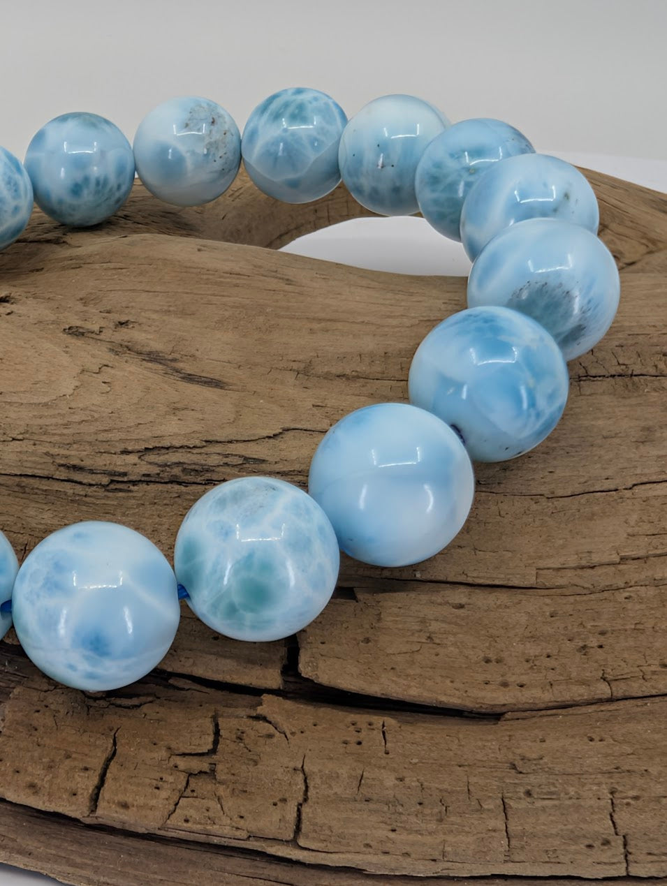 Close up of natural Larimar bracelet 11mm AA+ grade with strong Caribbean-blue marbling