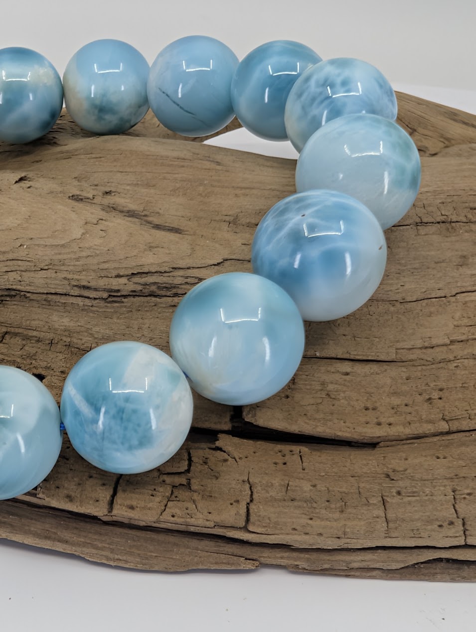 Close-up of premium 13.5mm Larimar beads showing natural blue marbling