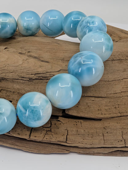 Close-up of premium 13.5mm Larimar beads showing natural blue marbling