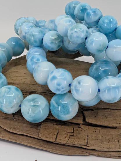 Group shot of natural Larimar bracelets highlighting Caribbean-blue tones