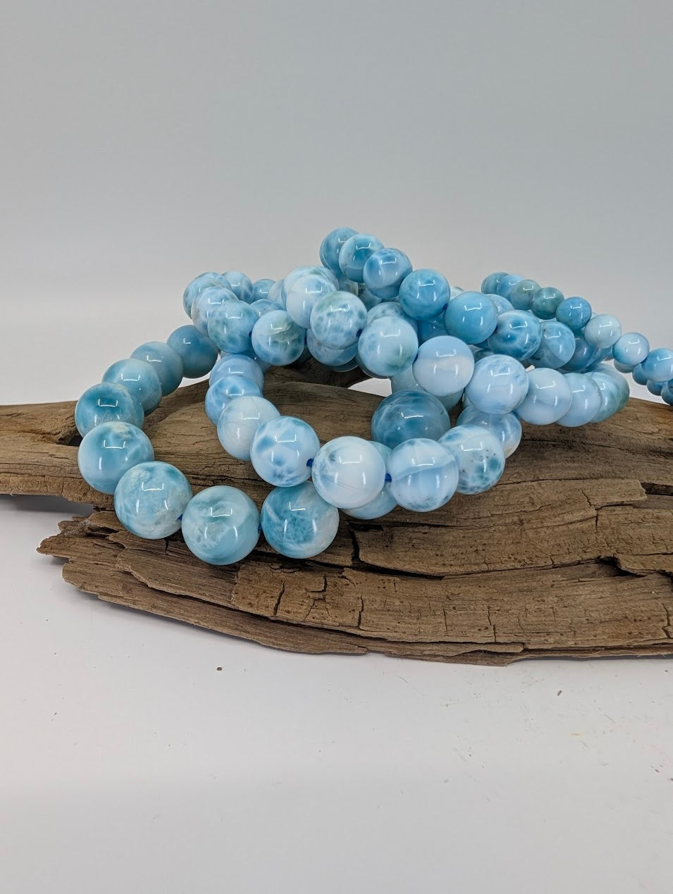 Premium AA–AA+ Larimar bracelet selection with polished blue beads