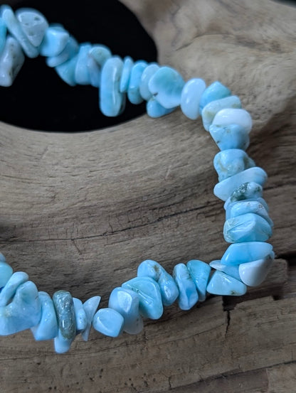 Close-up macro view of polished Larimar chips highlighting their smooth finish and vibrant sky-blue coloration.