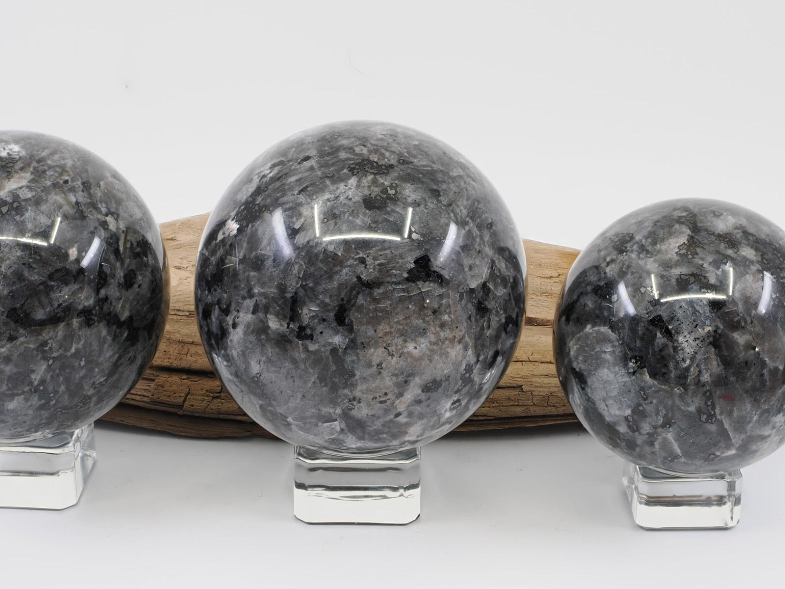 Top down view of Larvikite spheres showing silvery blue feldspar flash.