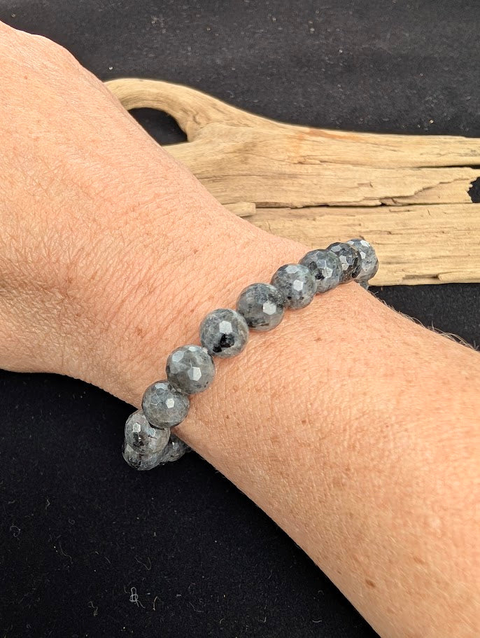 8mm faceted Larvikite beaded stretch bracelet worn on a wrist for size scale.