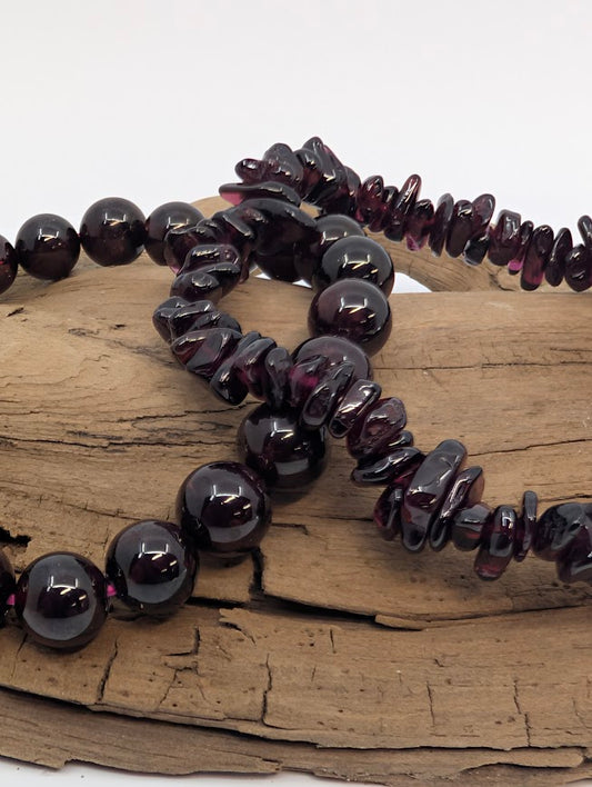 Close-up of deep red garnet beads showing polish and color