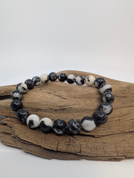 Zebra Jasper 8mm round bead stretch bracelet on driftwood with black-and-white banding