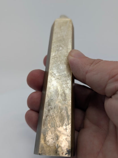 Golden Mica tower held in hand to show proportion and metallic reflectivity