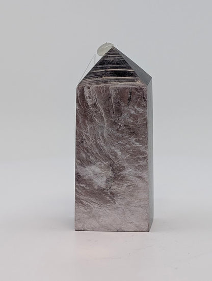 Angled view of Lepidolite (Purple Mica) tower showing color gradient and structure