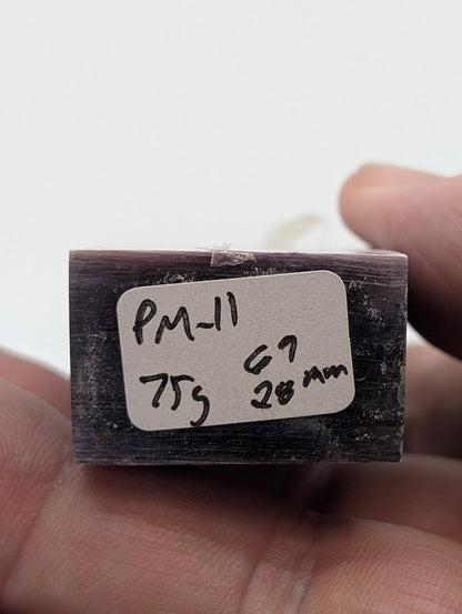 Base label of Lepidolite tower PM-11 showing 75 g weight and 6.9 cm × 2.8 cm dimensions