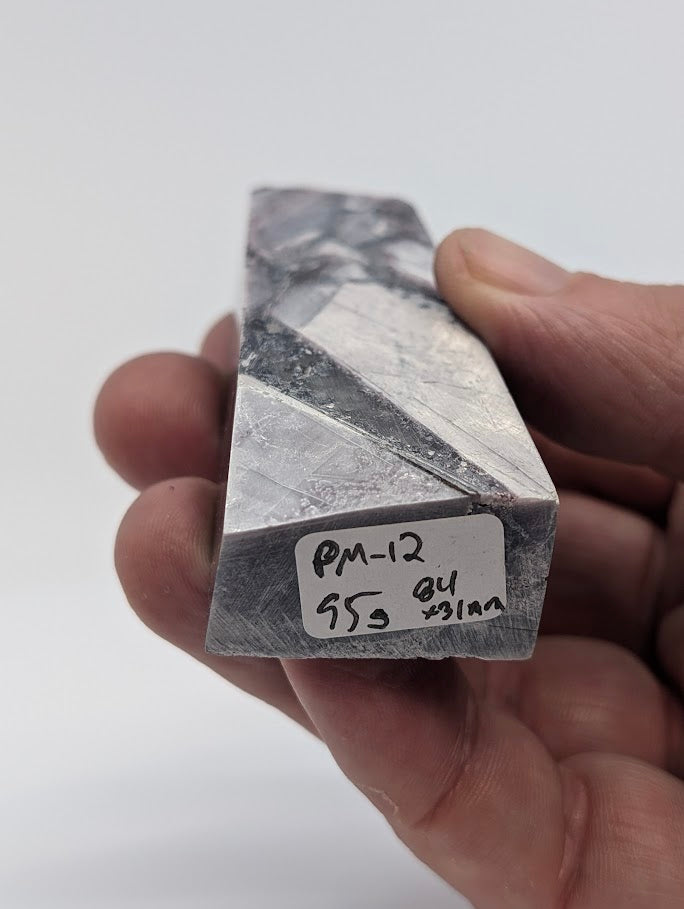 Base label of Lepidolite tower PM-12 showing 95 g weight and 8.4 × 3.1 cm dimensions