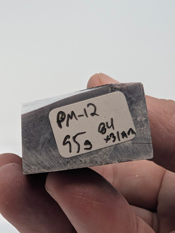 Base label of Lepidolite tower PM-12 showing 95 g weight and 8.4 × 3.1 cm dimensions