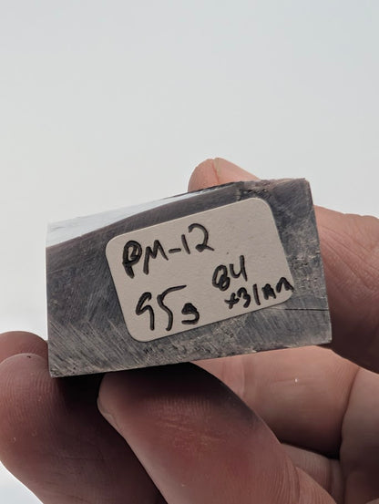Base label of Lepidolite tower PM-12 showing 95 g weight and 8.4 × 3.1 cm dimensions