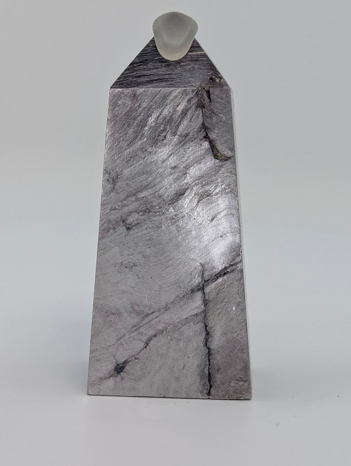 Angled front view of Lepidolite tower showing diagonal lilac veins and smooth polish