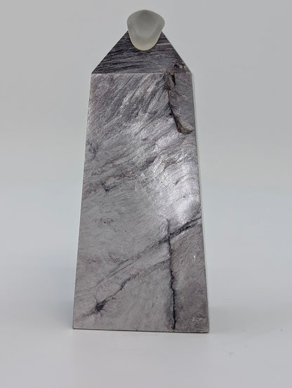 Angled front view of Lepidolite tower showing diagonal lilac veins and smooth polish