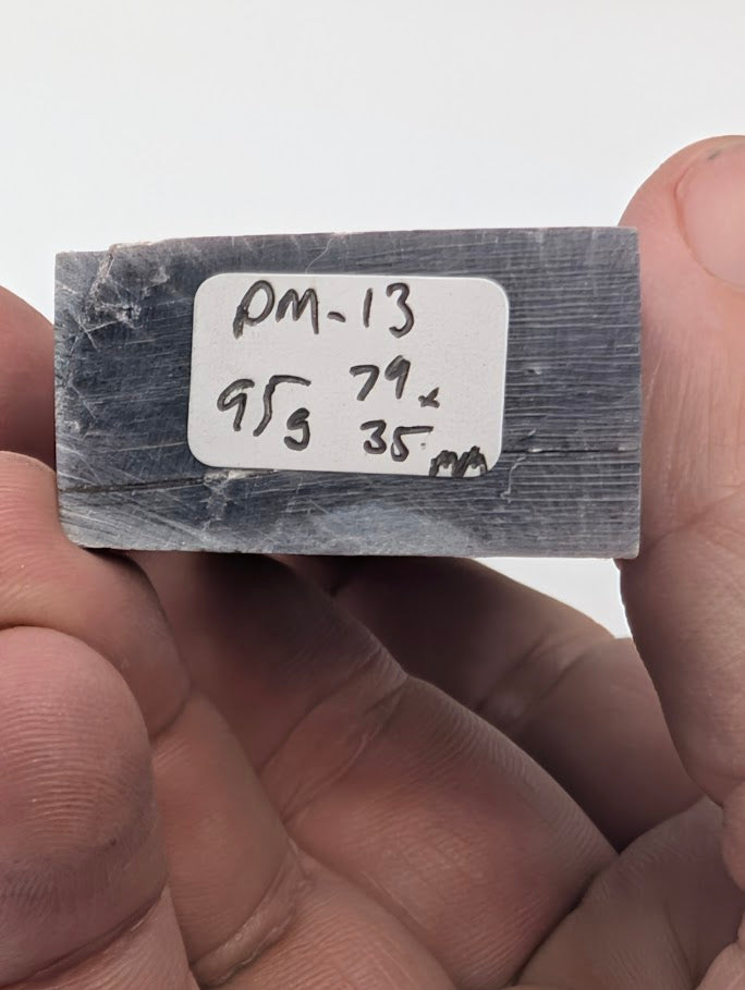 Base label of Lepidolite tower PM-13 showing 95 g weight and 7.9 × 3.5 cm dimensions