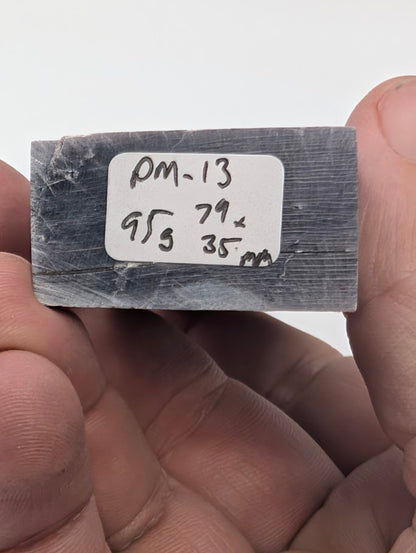 Base label of Lepidolite tower PM-13 showing 95 g weight and 7.9 × 3.5 cm dimensions