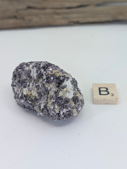 Saturated deep purple Lepidolite mica book showing dense crystalline structure and pearly luster.