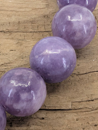 Macro view of 8mm Lepidolite beads showing natural micaceous flash and crystalline structures typical of Minas Gerais specimens.