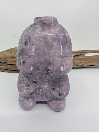 Front view of a hand-carved purple Lepidolite dinosaur specimen A from Brazil.