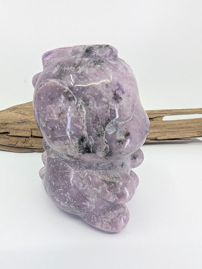 Hand-held view of the purple Lepidolite dinosaur providing a sense of scale and color saturation.
