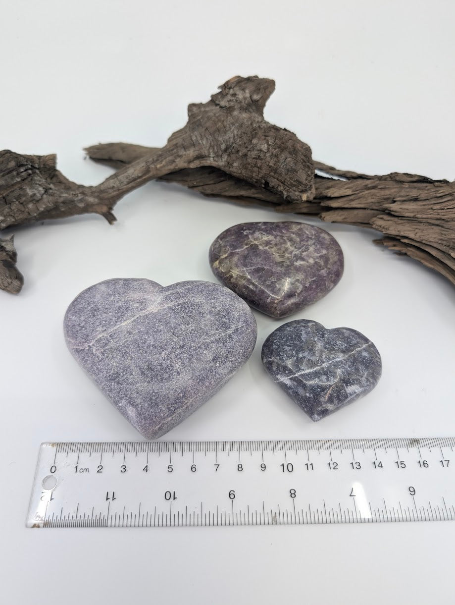 Group of three Lepidolite hearts showing Small, Medium, and Large sizes.