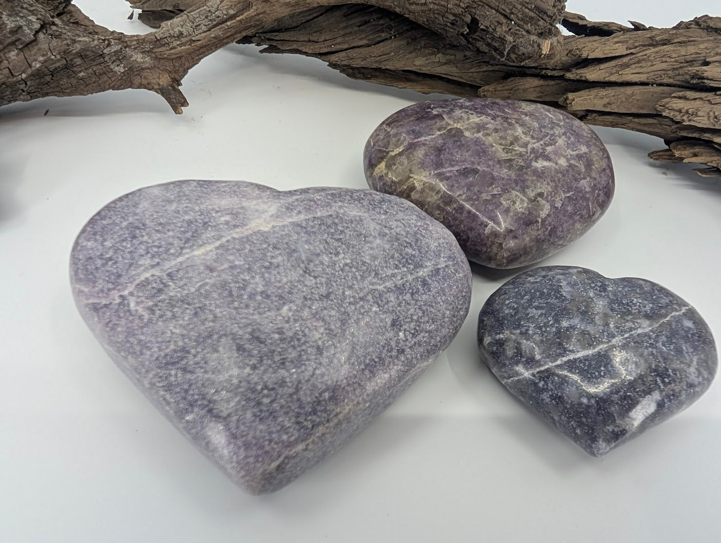 Group of three Lepidolite hearts showing Small, Medium, and Large sizes.