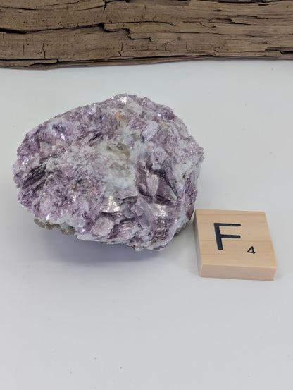Blocky Lepidolite mica specimen showing a mix of purple crystals and translucent matrix.