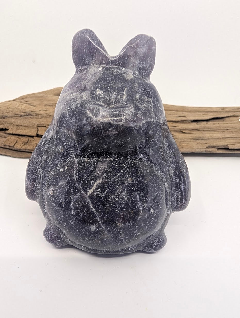 Front view of a lilac Lepidolite Totoro showing the pearlescent mica shimmer and lavender color.