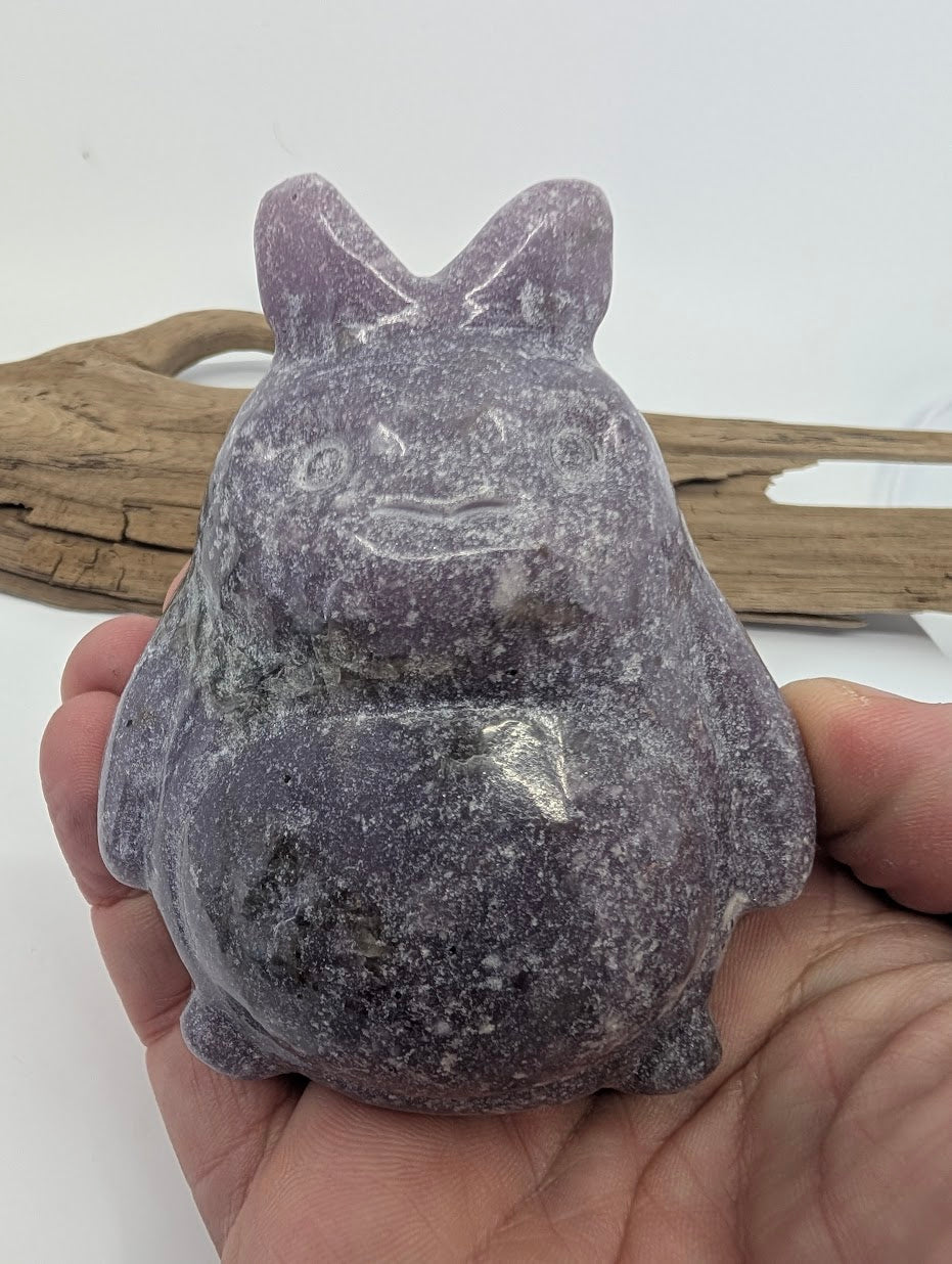 445g Lepidolite Totoro held in hand for scale against a white background.