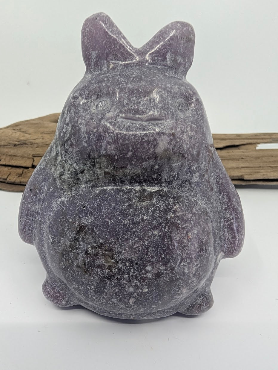 Alternate front view of a purple Lepidolite Totoro under direct lighting.