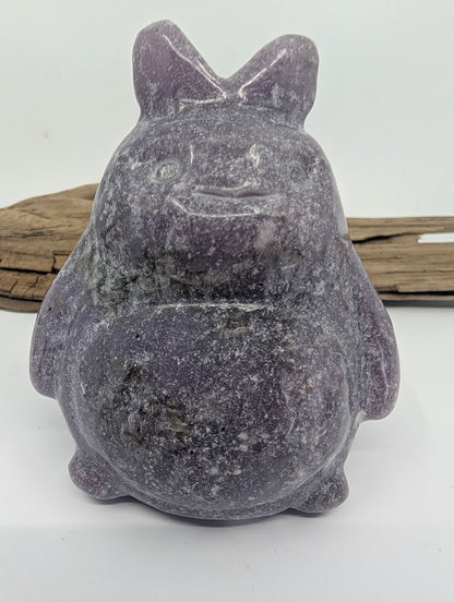 Alternate front view of a purple Lepidolite Totoro under direct lighting.