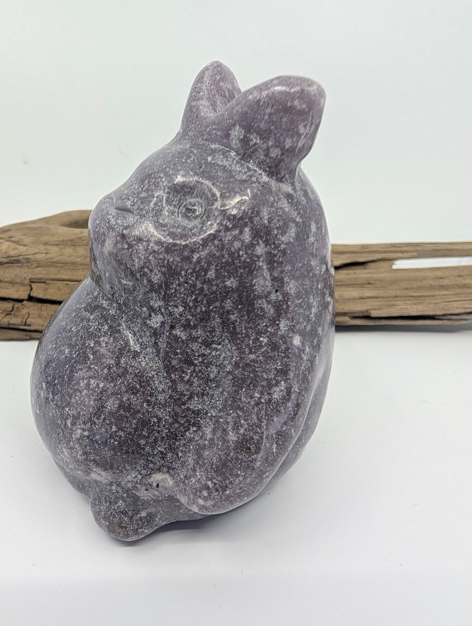 Angled view of a Lepidolite Totoro highlighting the micaceous texture of the natural stone.