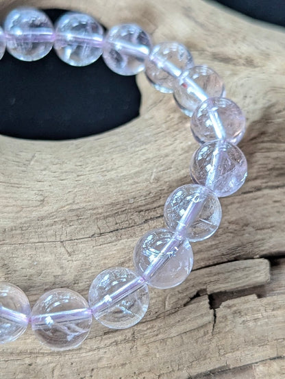 Macro detail shot of 10mm Bolivian Light Amethyst beads showing clean quartz structure and brilliant polish.