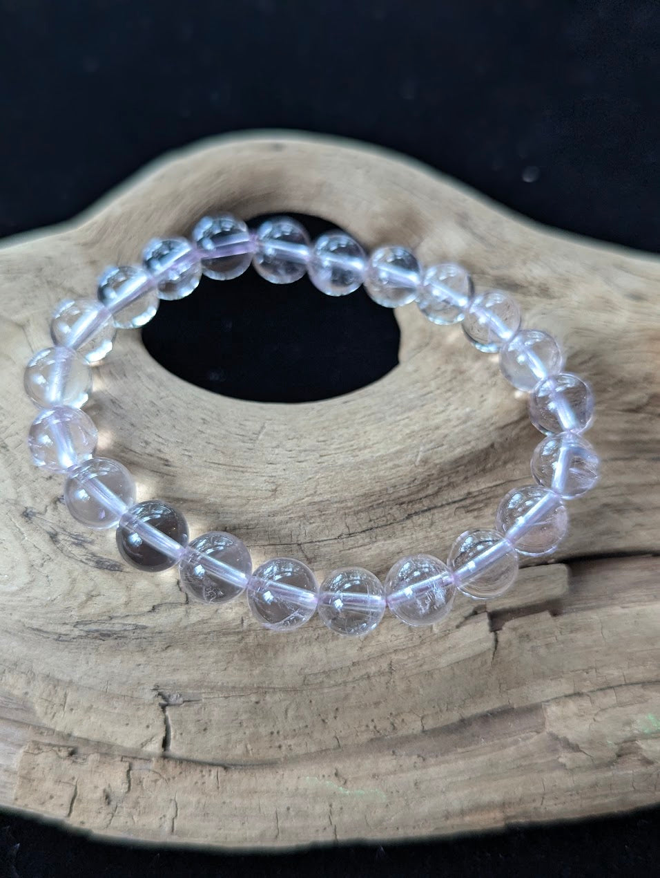 Close-up macro view of 9mm Light Amethyst beads displaying exceptional transparency and soft lavender saturation.