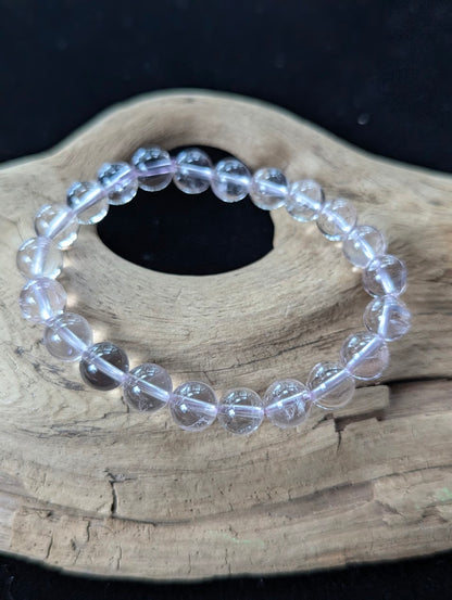 Close-up macro view of 9mm Light Amethyst beads displaying exceptional transparency and soft lavender saturation.