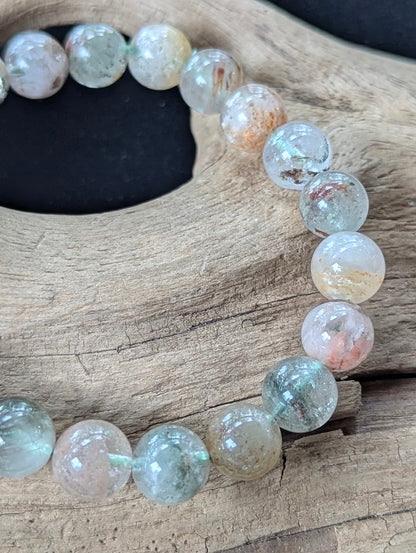 Close-up of 10mm Light Garden Quartz (Lodolite) Bracelet, highlighting scenic formations inside the quartz.