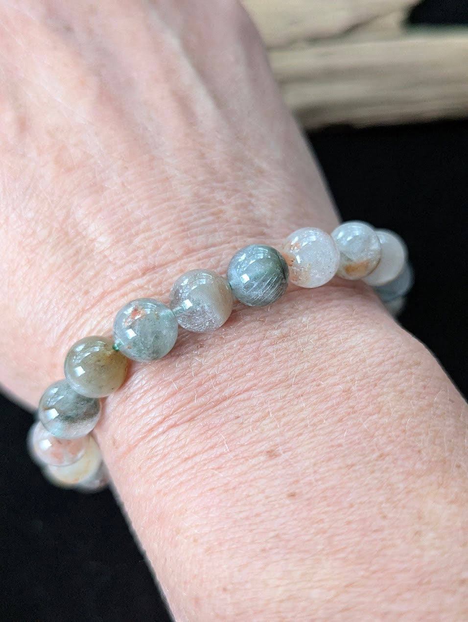 10mm Light Garden Quartz (Lodolite) Bracelet shown worn on a wrist.