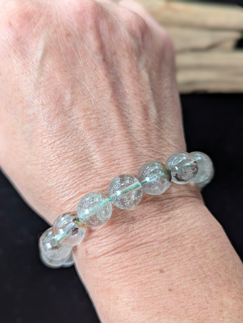 Substantial 11mm Light Garden Quartz (Lodolite) Bracelet shown worn on a wrist.