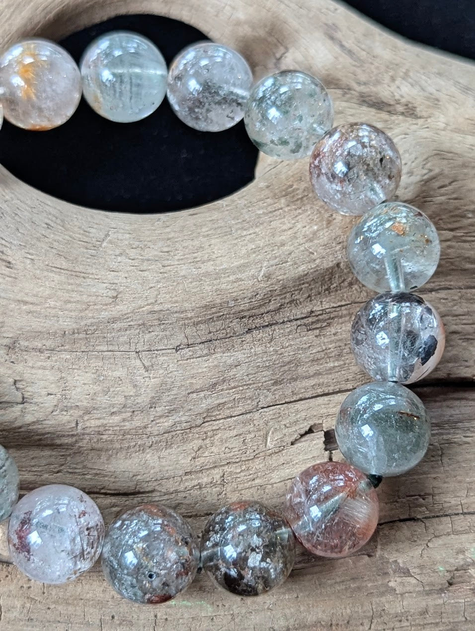 Close-up of 12mm Light Garden Quartz (Lodolite) Bracelet, highlighting large scenic formations inside the clear quartz.