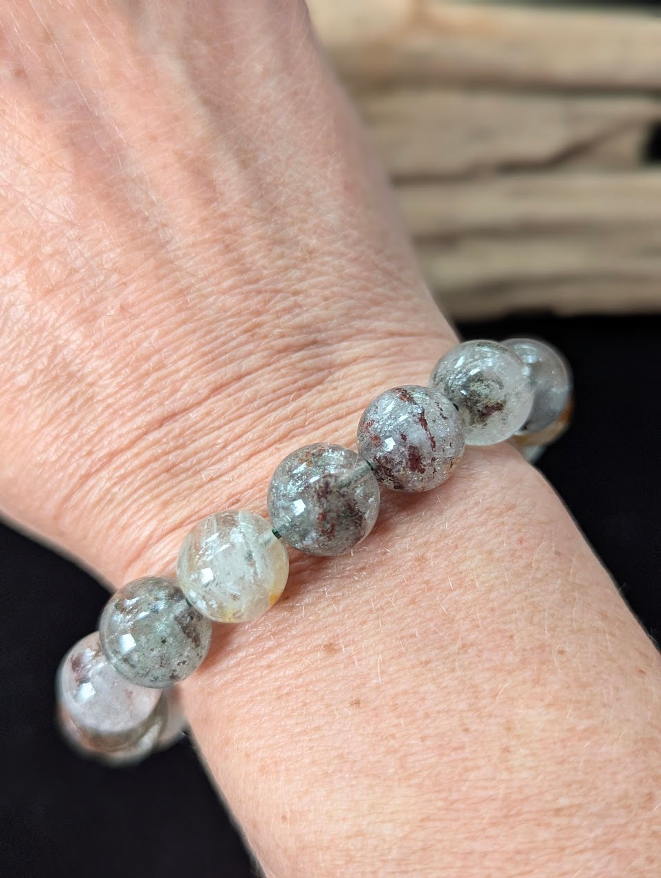 Substantial 12mm Light Garden Quartz (Lodolite) Bracelet shown worn on a wrist.